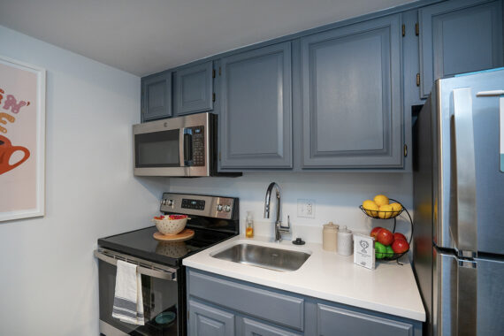 Apartment kitchen furnished with stainless steel appliances