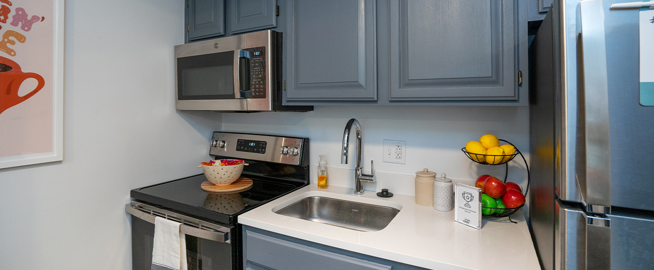 Apartment kitchen furnished with stainless steel appliances